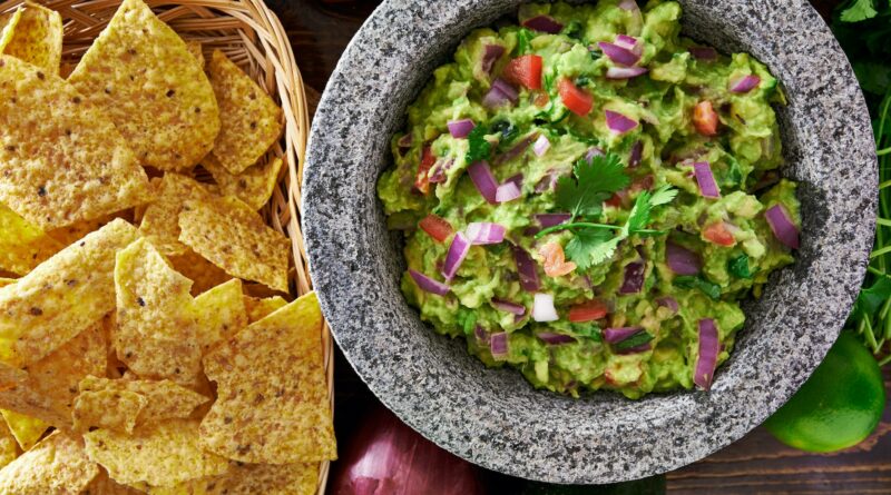 mexican guacamole in molcajete with tortilla chips