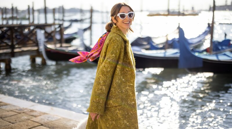Stylish woman walking in Venice, Italy