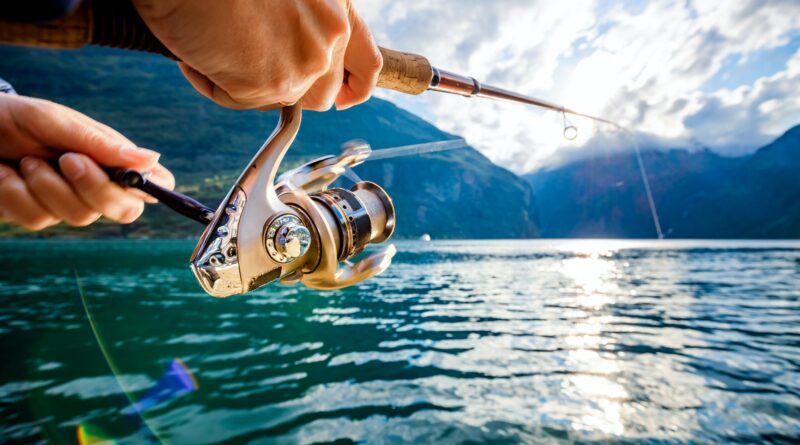 Woman fishing on Fishing rod spinning in Norway.