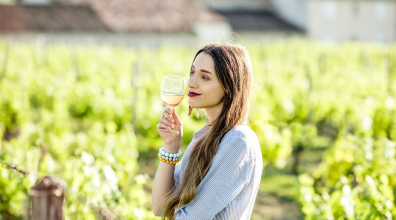 Woman tasting wine outdoors