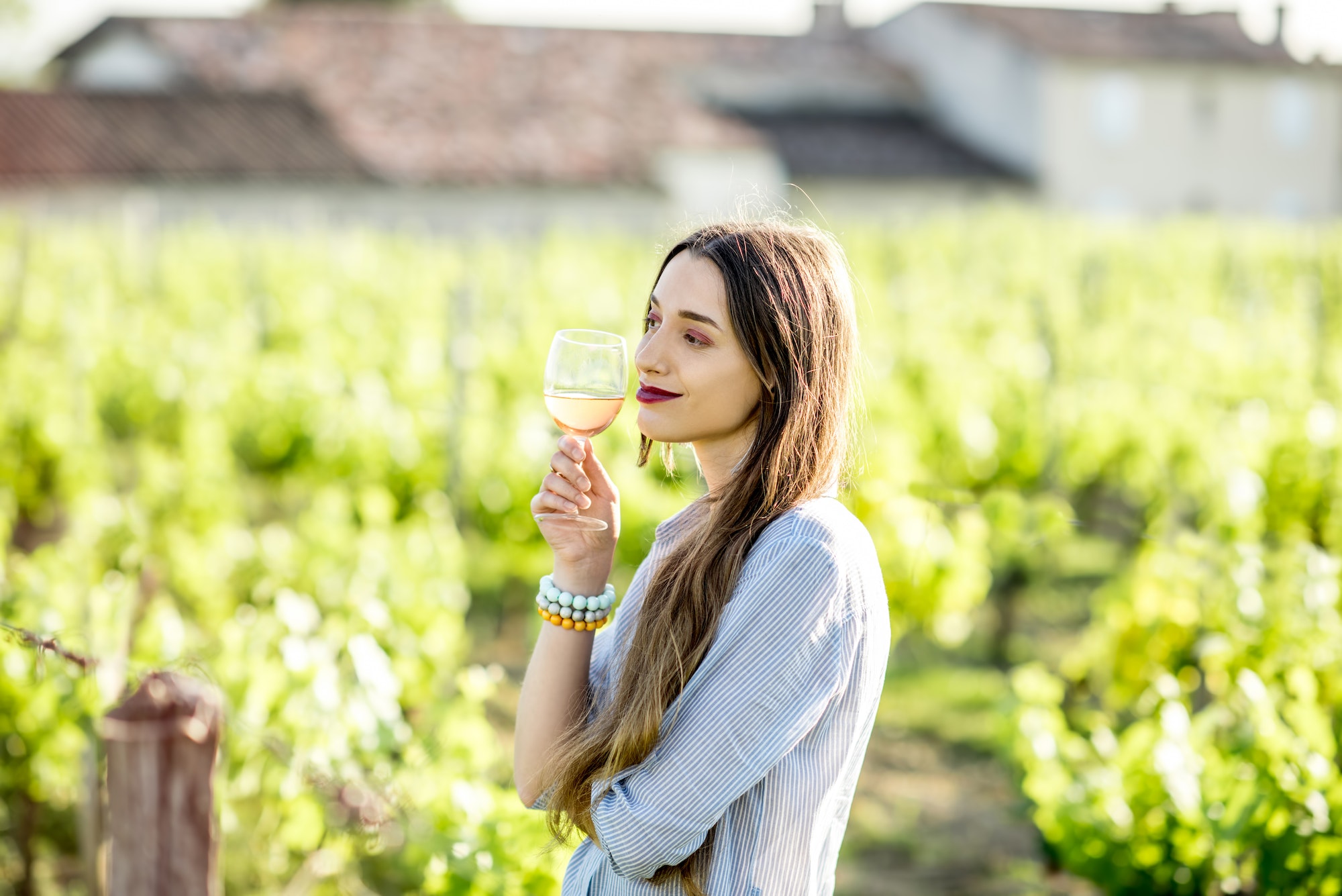 Woman tasting wine outdoors